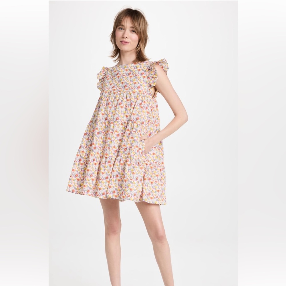 Tired baby doll dress with flutter sleeves. Floral mini dress!